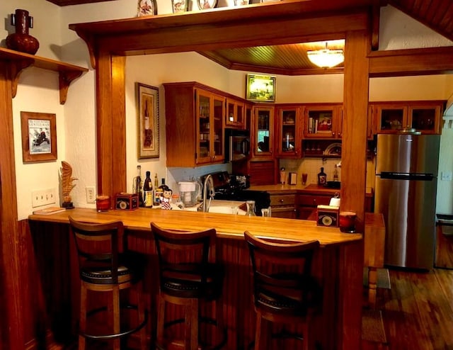 1001 S Locust St, Clarksville, TX 75426 - indoor bar featuring stainless steel appliances, wood finished floors, and tasteful backsplash