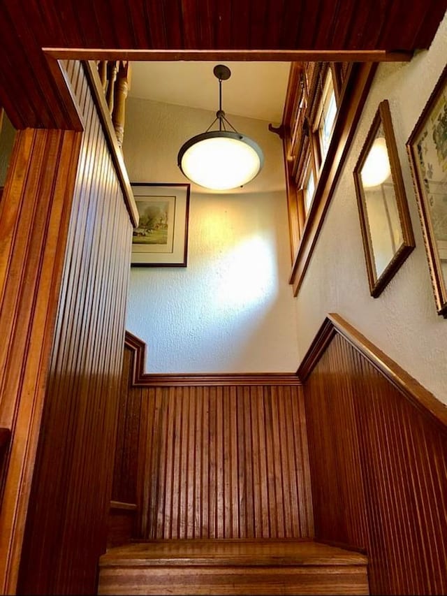 1001 S Locust St, Clarksville, TX 75426 - stairs with a wainscoted wall and wooden walls