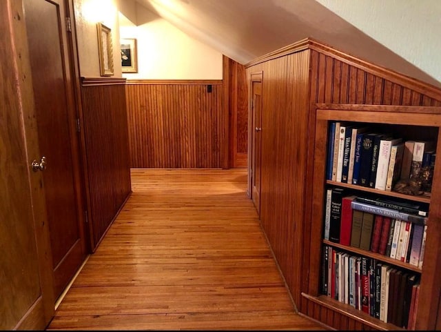 1001 S Locust St, Clarksville, TX 75426 - corridor with vaulted ceiling, wood finished floors, wooden walls, and wainscoting