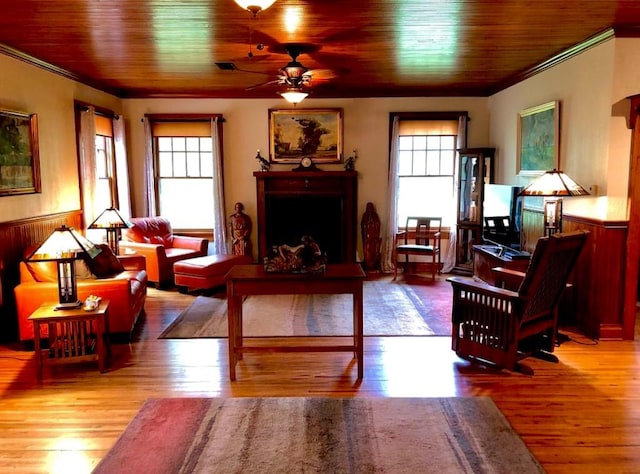 1001 S Locust St, Clarksville, TX 75426 - living room with healthy amount of natural light, ceiling fan, ornamental molding, wood finished floors, and wood ceiling
