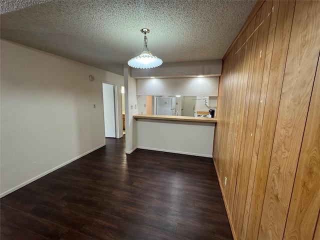 397 Somerset Pl, Abilene, TX 79601 - unfurnished dining area featuring wood finished floors, a textured ceiling, and baseboards