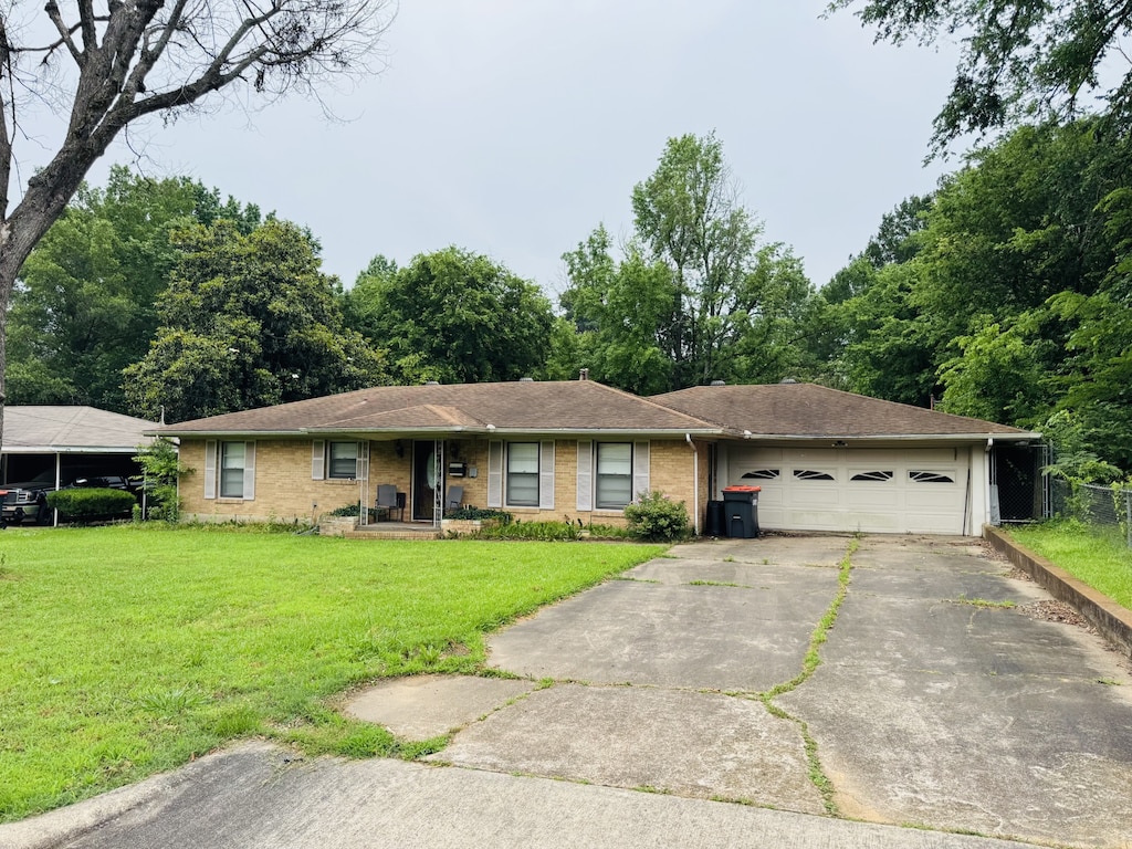 2440 Cleveland, Paris, TX 75460 - single story home with a garage, driveway, a front yard, and a porch