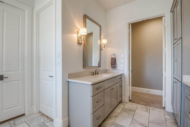 6009 Westchester Ln, Frisco, TX 75034 - bathroom featuring marble look tile flooring, vanity, and baseboards