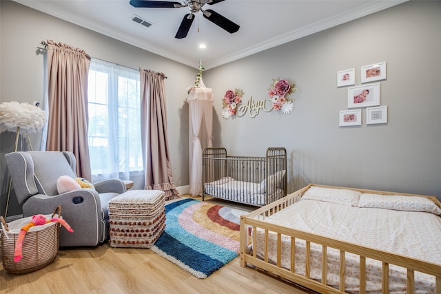 6009 Westchester Ln, Frisco, TX 75034 - bedroom featuring wood finished floors, ornamental molding, a crib, a ceiling fan, and recessed lighting