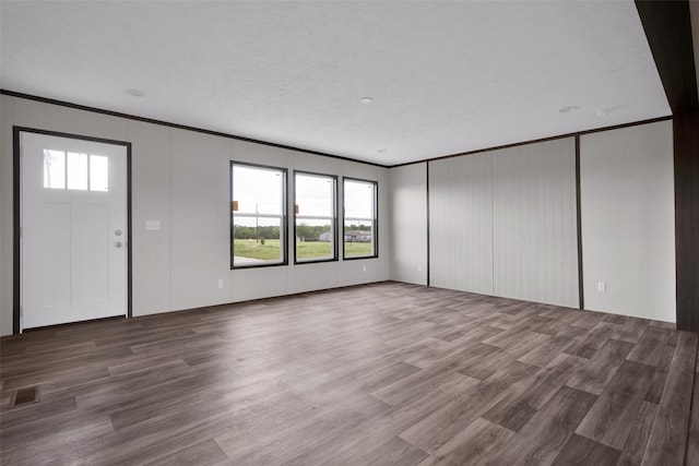 1203 Old Ida Rd, Sherman, TX 75090 - unfurnished living room featuring wood finished floors, crown molding, and a decorative wall