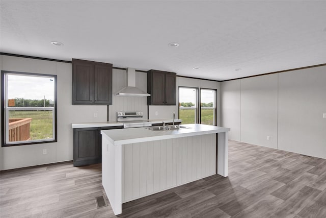 1203 Old Ida Rd, Sherman, TX 75090 - kitchen featuring wall chimney exhaust hood, stainless steel electric stove, a sink, light countertops, and an island with sink