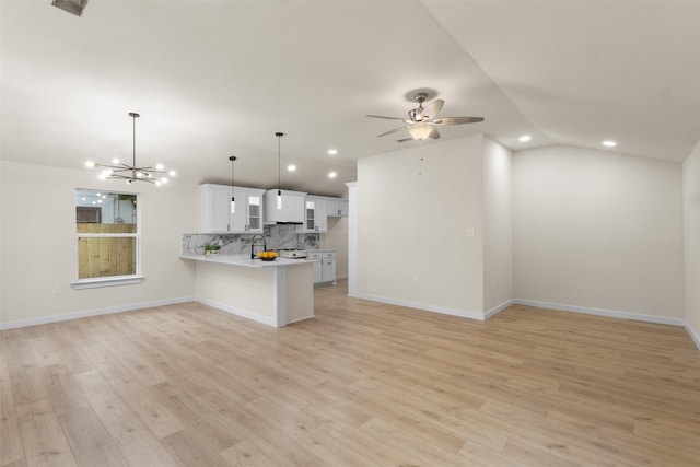 1832 Arch St, Fort Worth, TX 76105 - kitchen featuring vaulted ceiling, open floor plan, light countertops, a peninsula, and decorative backsplash