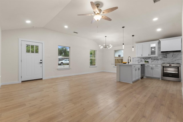1832 Arch St, Fort Worth, TX 76105 - kitchen featuring stainless steel appliances, vaulted ceiling, open floor plan, a peninsula, and plenty of natural light