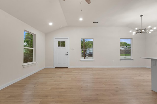 1832 Arch St, Fort Worth, TX 76105 - unfurnished living room with lofted ceiling, light wood-style flooring, a chandelier, a ceiling fan, and baseboards