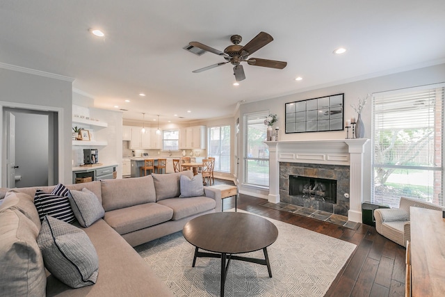 415 Saddle Tree Trl, Coppell, TX 75019 - living area featuring crown molding, ceiling fan, recessed lighting, dark wood-style flooring, and a tile fireplace