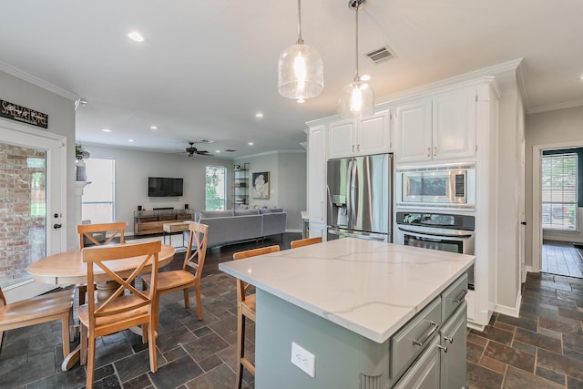 415 Saddle Tree Trl, Coppell, TX 75019 - kitchen with stainless steel appliances, ornamental molding, plenty of natural light, stone tile floors, and recessed lighting