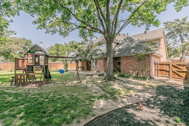 415 Saddle Tree Trl, Coppell, TX 75019 - view of yard featuring a playground and a gate