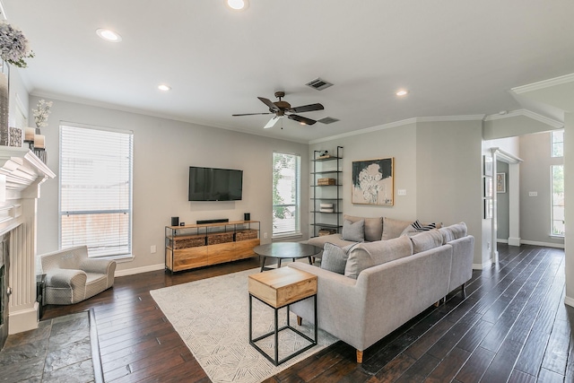 415 Saddle Tree Trl, Coppell, TX 75019 - living room with a fireplace, dark wood-type flooring, plenty of natural light, a ceiling fan, and crown molding