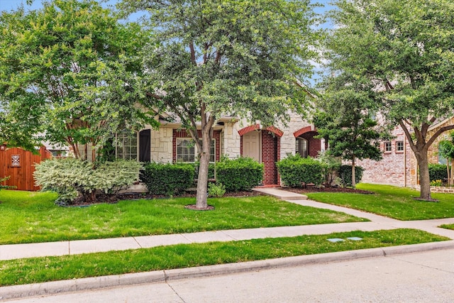 906 Cougar Dr, Allen, TX 75013 - view of property hidden behind natural elements with stone siding and a front lawn