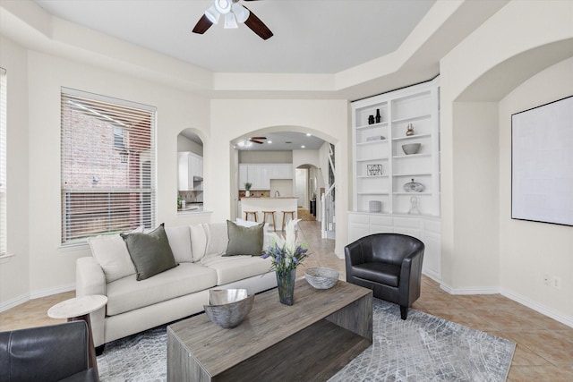 906 Cougar Dr, Allen, TX 75013 - living area with ceiling fan, arched walkways, light tile patterned floors, baseboards, and built in features