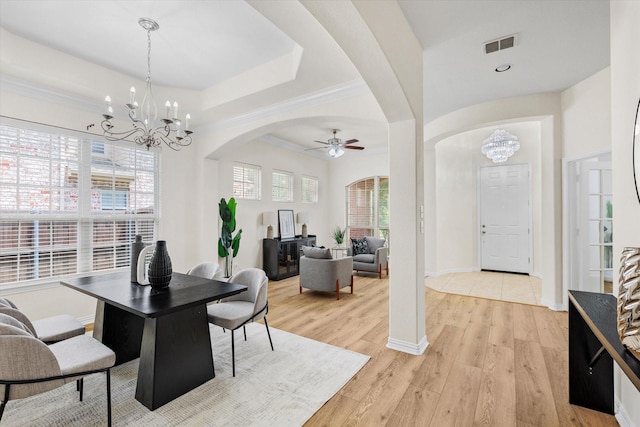 906 Cougar Dr, Allen, TX 75013 - dining room with a chandelier, a ceiling fan, arched walkways, light wood finished floors, and baseboards