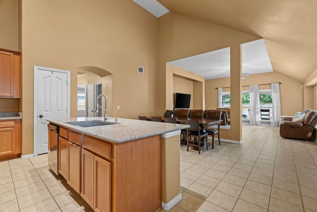 632 Shotwell St, Crowley, TX 76036 - kitchen with dishwasher, open floor plan, a sink, light tile patterned flooring, and arched walkways