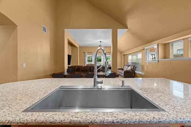 632 Shotwell St, Crowley, TX 76036 - kitchen with a sink, open floor plan, vaulted ceiling, and light stone counters