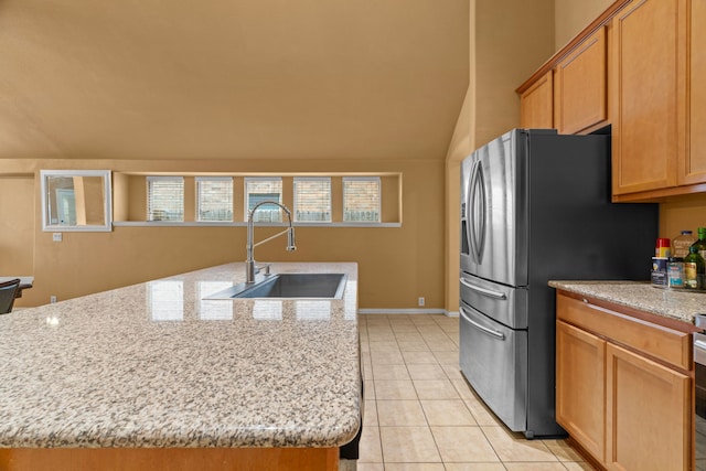 632 Shotwell St, Crowley, TX 76036 - kitchen with a sink, stainless steel fridge with ice dispenser, light tile patterned floors, light stone counters, and lofted ceiling