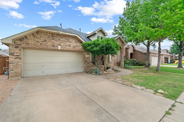 632 Shotwell St, Crowley, TX 76036 - view of front of house featuring brick siding, driveway, a front yard, and an attached garage