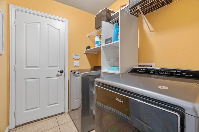 632 Shotwell St, Crowley, TX 76036 - clothes washing area with washer and dryer and light tile patterned floors
