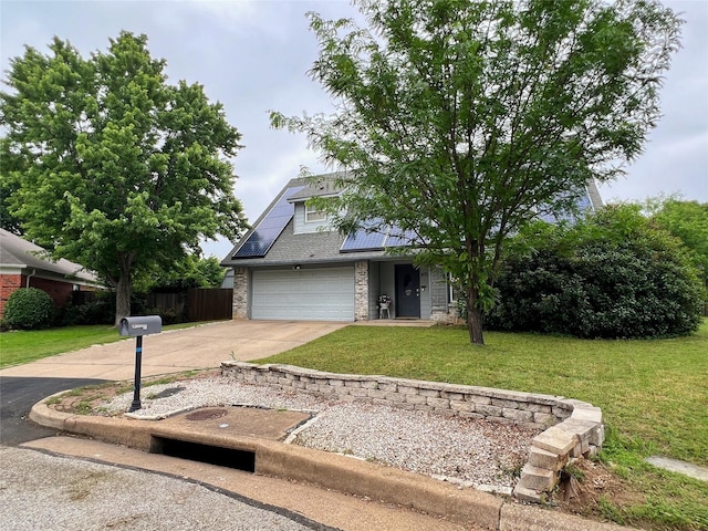 view of front of home with roof mounted solar panels and concrete driveway