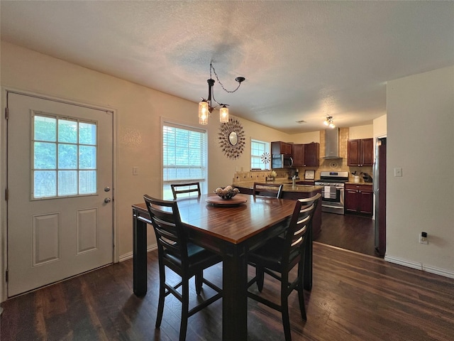 dining area featuring dark wood-style flooring, a chandelier, and baseboards