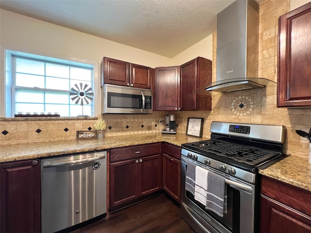 kitchen with stainless steel appliances, wall chimney range hood, dark wood-style floors, backsplash, and a textured ceiling
