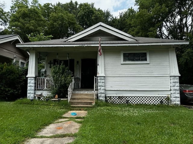 bungalow with a front lawn and a porch