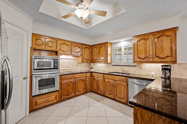 4006 Thornhill Way, Rowlett, TX 75088 - kitchen featuring appliances with stainless steel finishes, a sink, brown cabinetry, ornamental molding, and a textured ceiling