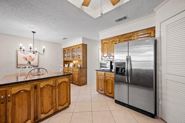 4006 Thornhill Way, Rowlett, TX 75088 - kitchen featuring stainless steel fridge with ice dispenser, brown cabinets, light tile patterned flooring, a ceiling fan, and a chandelier