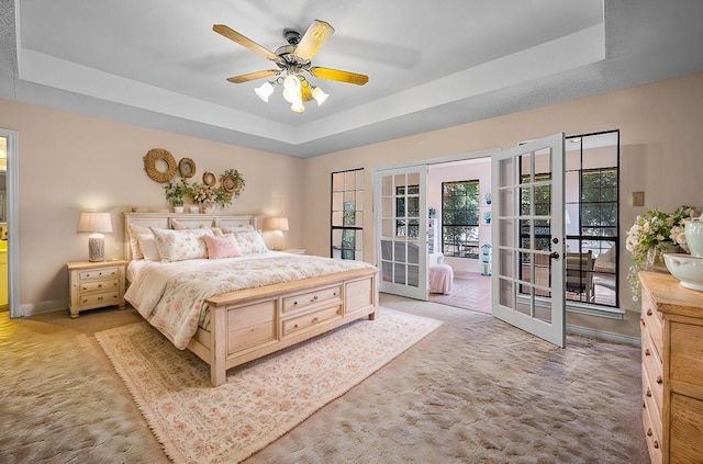 4006 Thornhill Way, Rowlett, TX 75088 - bedroom with a tray ceiling, french doors, carpet flooring, access to exterior, and baseboards