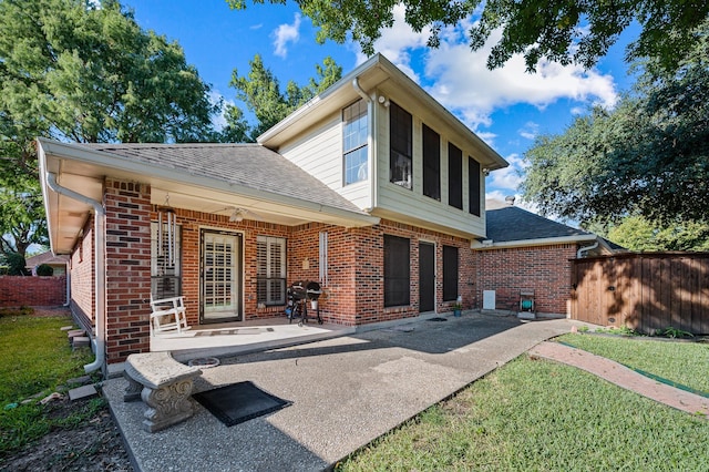 4006 Thornhill Way, Rowlett, TX 75088 - back of house with a shingled roof, brick siding, asphalt driveway, a patio, and an attached garage