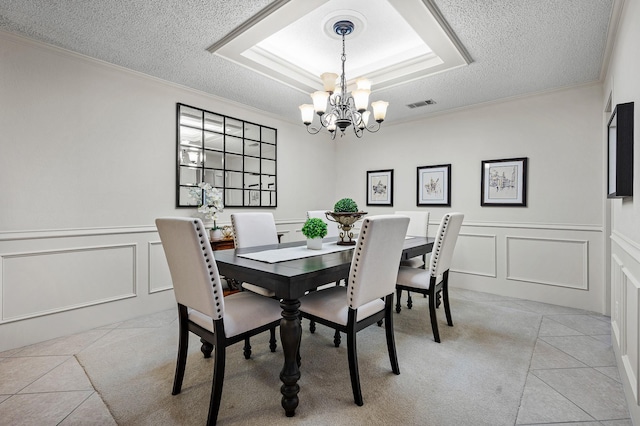 4006 Thornhill Way, Rowlett, TX 75088 - dining space featuring a decorative wall, a chandelier, light tile patterned floors, a textured ceiling, and crown molding