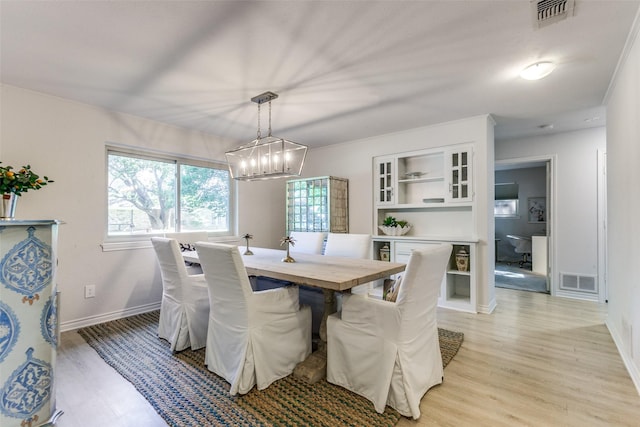 7403 Authon Dr, Dallas, TX 75248 - dining room featuring light wood-style flooring, a chandelier, and baseboards