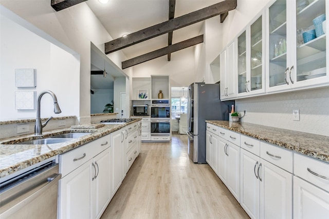 7403 Authon Dr, Dallas, TX 75248 - kitchen with stainless steel appliances, a sink, white cabinets, and light stone countertops
