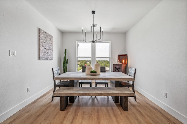 5219 Old Dennis Rd, Weatherford, TX 76087 - dining area with a chandelier, light wood-type flooring, baseboards, and a textured wall