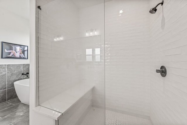 5219 Old Dennis Rd, Weatherford, TX 76087 - full bathroom with tiled shower, tile walls, and a freestanding tub