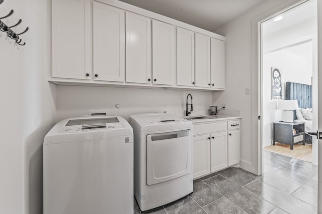5219 Old Dennis Rd, Weatherford, TX 76087 - washroom featuring cabinet space, separate washer and dryer, and marble finish flooring