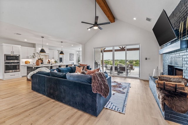 5219 Old Dennis Rd, Weatherford, TX 76087 - living area with high vaulted ceiling, beam ceiling, a ceiling fan, recessed lighting, and a brick fireplace