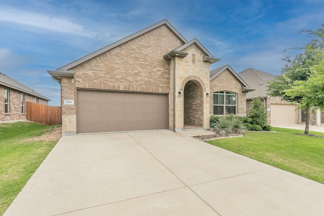 136 Wagon Mound, Waxahachie, TX 75167 - french provincial home with brick siding, an attached garage, and concrete driveway