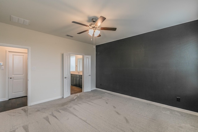 136 Wagon Mound, Waxahachie, TX 75167 - unfurnished bedroom with carpet flooring, baseboards, connected bathroom, and a ceiling fan