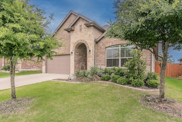136 Wagon Mound, Waxahachie, TX 75167 - french country style house with brick siding, concrete driveway, an attached garage, and stone siding