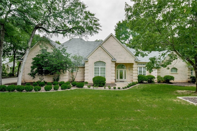 7712 Ravenswood Rd, Granbury, TX 76049 - view of front of house with a front yard and a shingled roof
