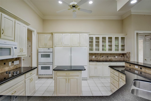 7712 Ravenswood Rd, Granbury, TX 76049 - kitchen with white appliances, a sink, crown molding, a ceiling fan, and decorative backsplash