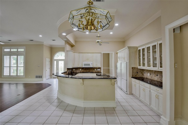 7712 Ravenswood Rd, Granbury, TX 76049 - kitchen with white appliances, dark countertops, light tile patterned floors, glass insert cabinets, and crown molding