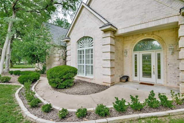 7712 Ravenswood Rd, Granbury, TX 76049 - doorway to property featuring roof with shingles and brick siding