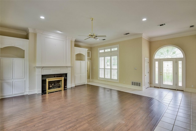 7712 Ravenswood Rd, Granbury, TX 76049 - unfurnished living room featuring ceiling fan, wood finished floors, a fireplace, ornamental molding, and baseboards