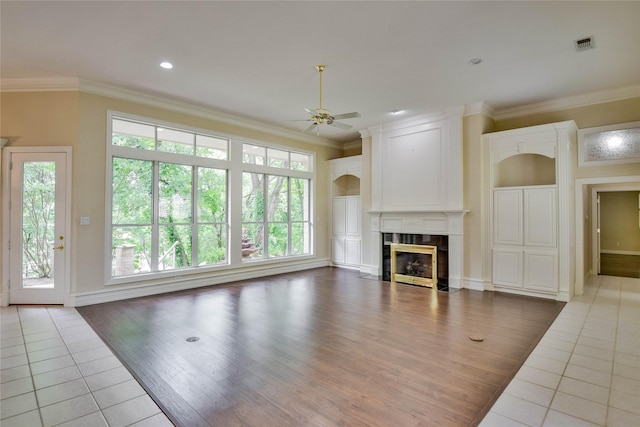 7712 Ravenswood Rd, Granbury, TX 76049 - unfurnished living room with a ceiling fan, wood finished floors, ornamental molding, a fireplace, and baseboards