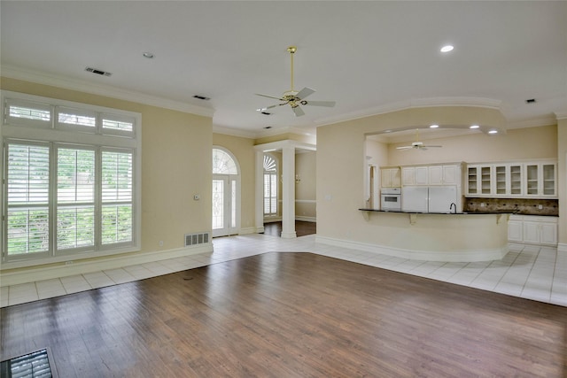 7712 Ravenswood Rd, Granbury, TX 76049 - unfurnished living room with ceiling fan, light wood-style flooring, crown molding, recessed lighting, and a sink